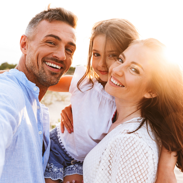 Family of 3 Smiling Outdoors