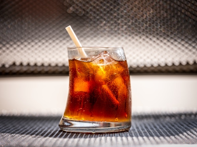 small glass of soda with a straw